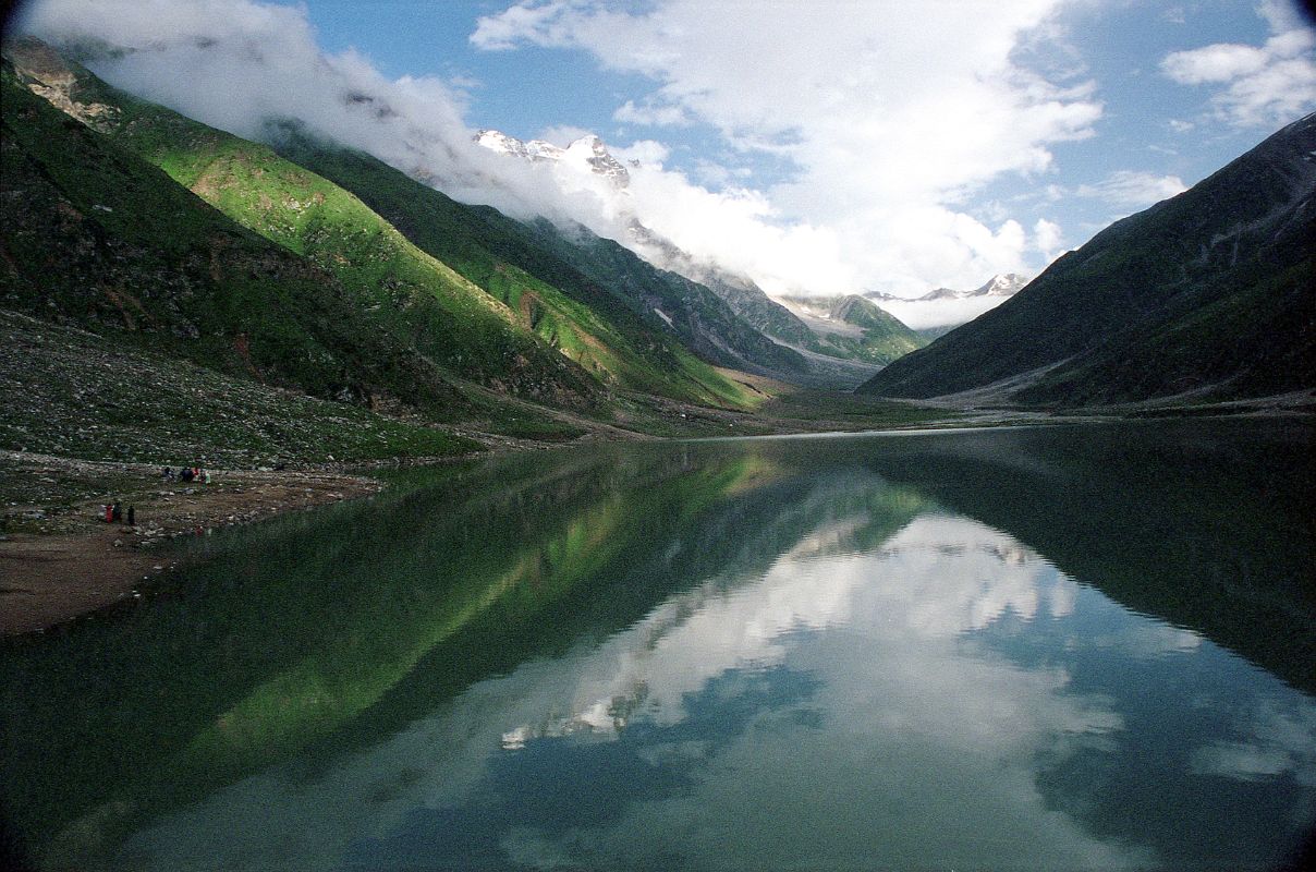 13 Lake Saiful Maluk With Malika Parbat In Kaghan Valley  Ilys drove 9km from Naran in half an hour up 770m to Lake Saiful Maluk (3200m). The overcast skies slowly parted to reveal this beautiful lake, set in alpine surroundings. The water reflects the surrounding peak of Malika Parbat (5290m).